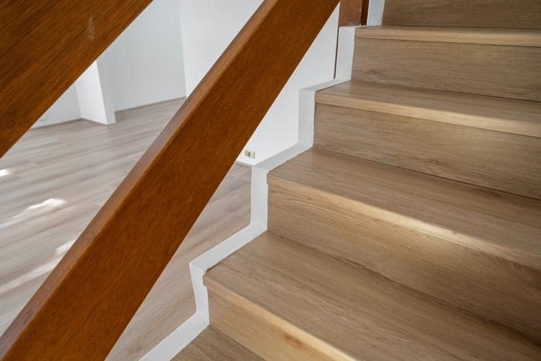 Close-up of oak stair treads and a timber handrail in a Sydney renovation