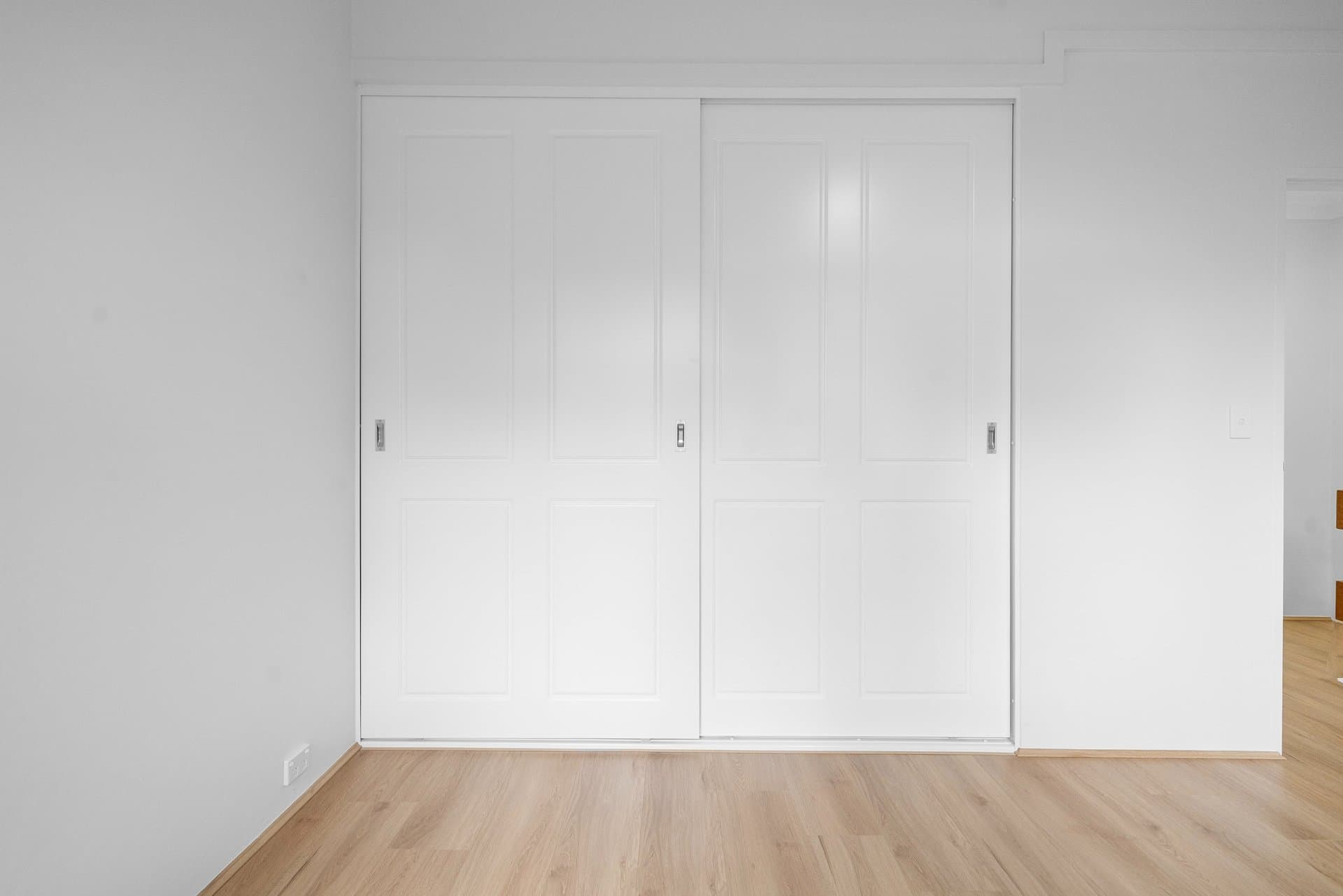 Sydney wardrobe with white sliding doors and oak floors