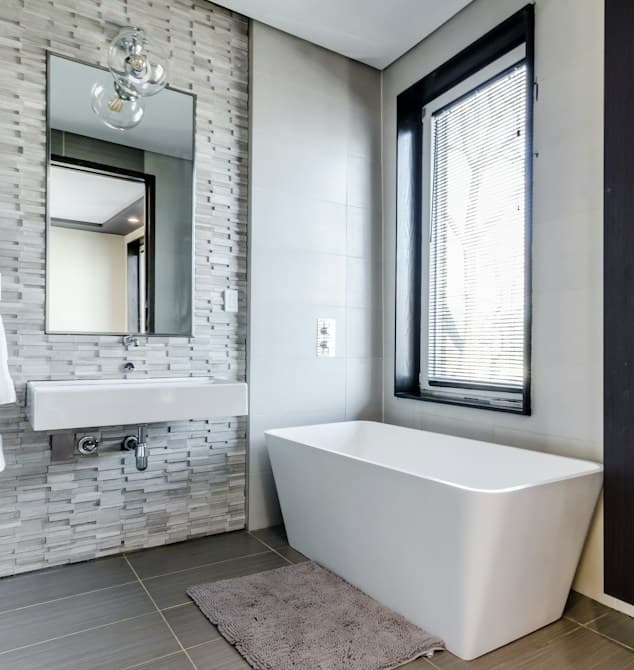 Minimal Sydney bathroom with a freestanding bath, wall basin and mosaic feature wall